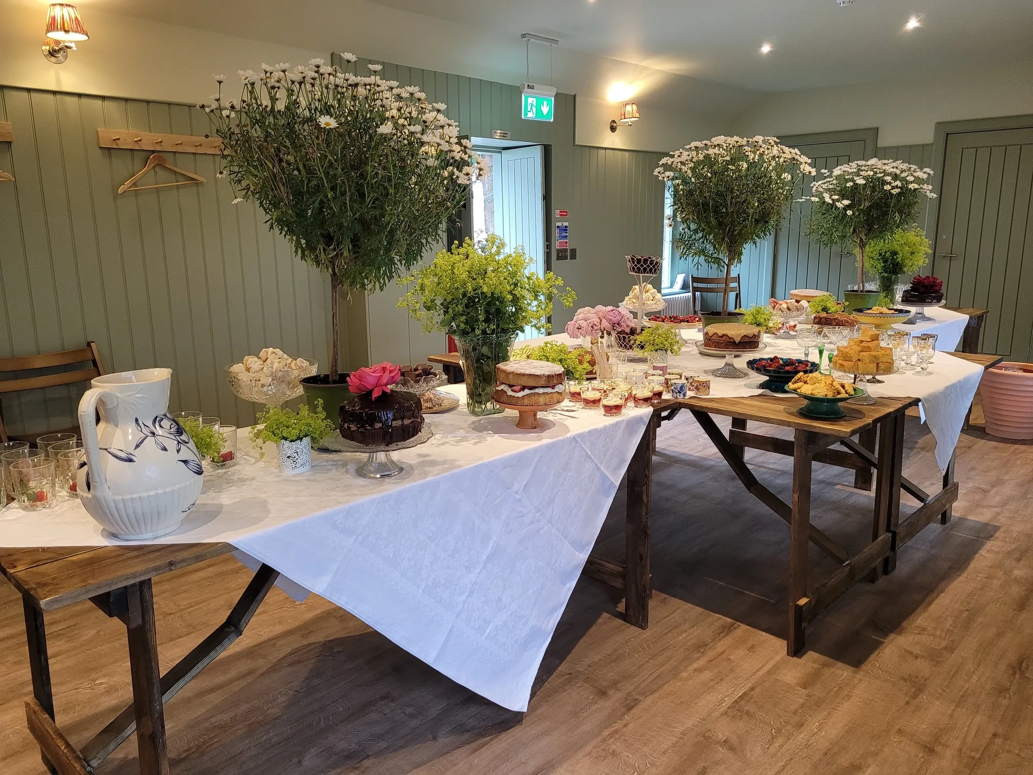 Interior of Toll Green Hall set up for an event with tables and flowers