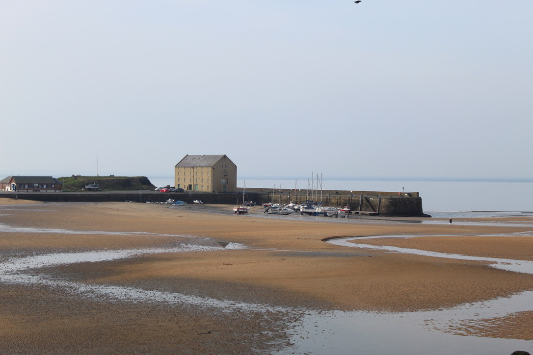 Elie harbour at low tide with boats and harbour buildings